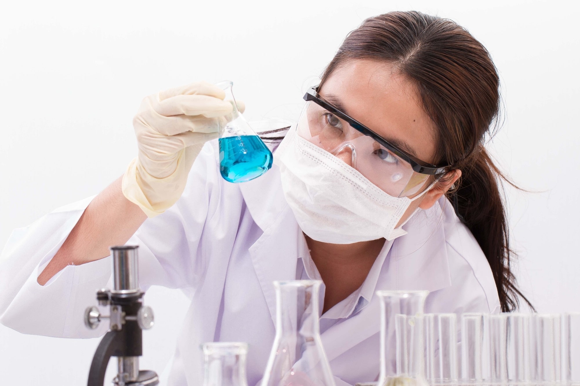 Lab Technician Holding a Beaker With Blue Liquid